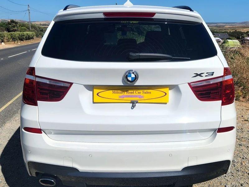 A white BMW X3 viewed from the back