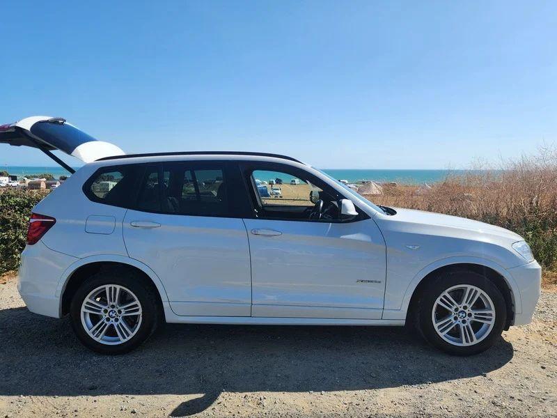 A white BMW X3 viewed from the driver side