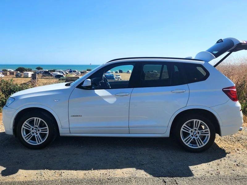 A white BMW X3 viewed from the passenger side