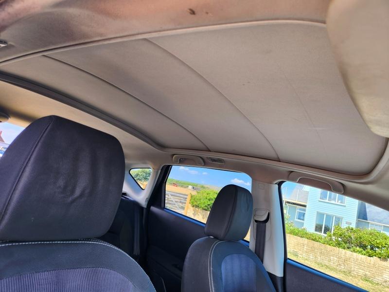 The covered sunroof of a black Nissan Qashqai viewed from the driver seat