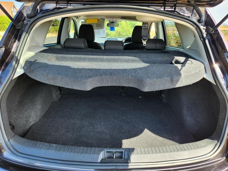 The open boot of a black Nissan Qashqai viewed from the back
