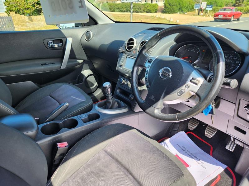 The steering controls of a black Nissan Qashqai viewed from above the driver seat