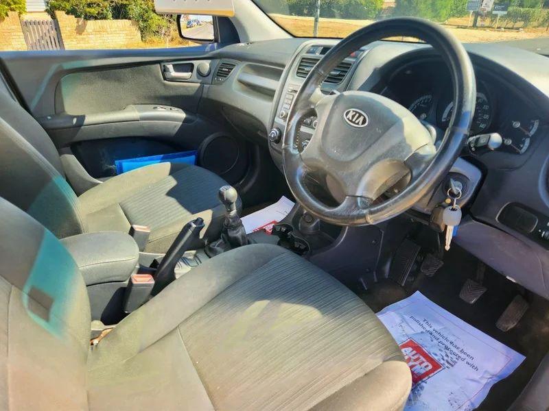The steering controls of a black Kia Sportage viewed from above the driver seat