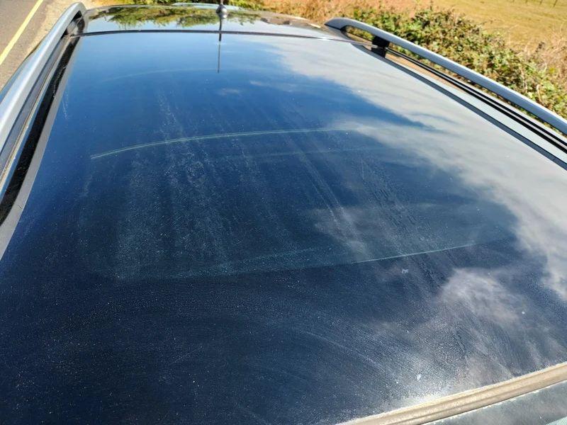 The sunroof of a black Nissan Qashqai viewed from above