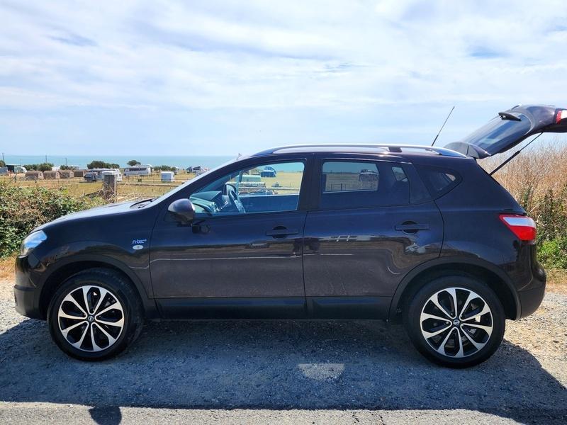 A black Nissan Qashqai viewed from the passenger side