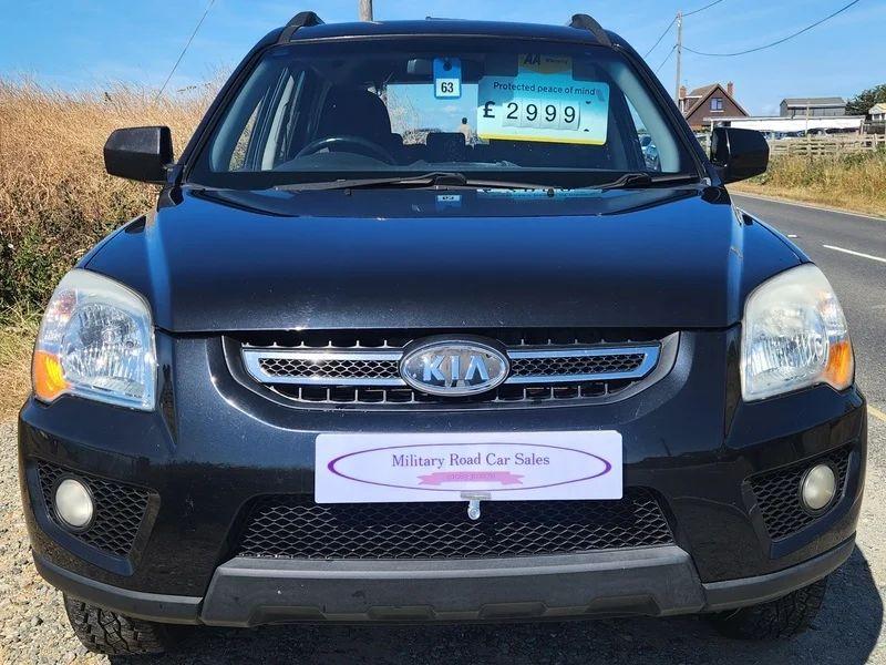A black Kia Sportage viewed from the front