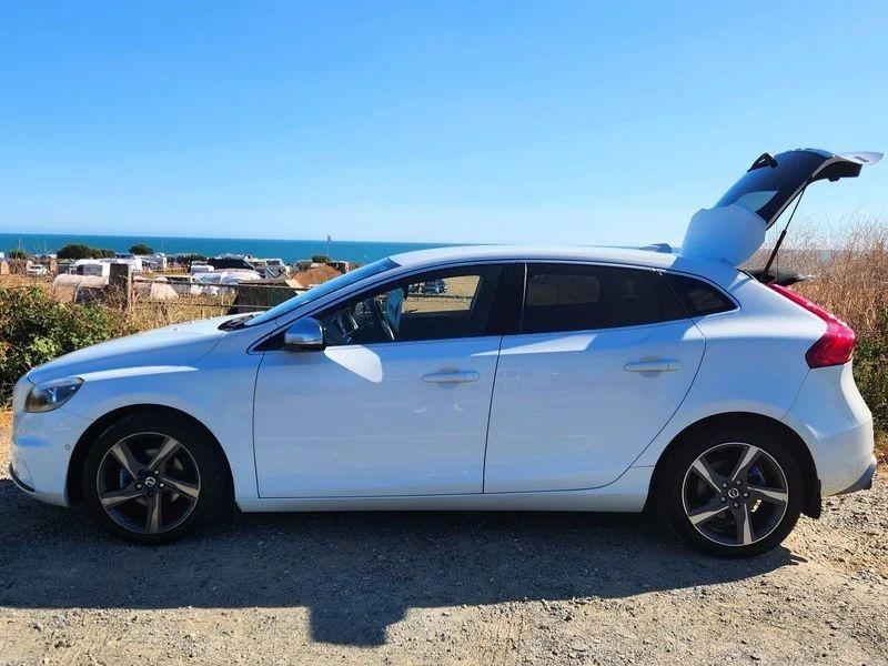A white Volvo V40 viewed from the passenger side