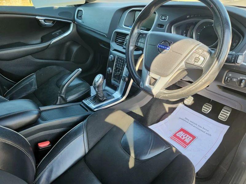 The steering controls of a white Volvo V40 viewed from above the driver seat