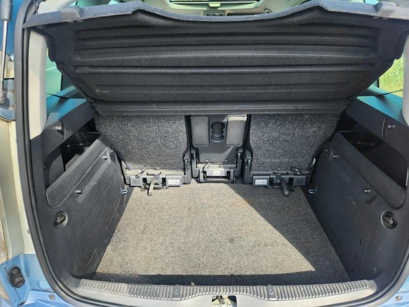 The open boot of a silver-blue Skoda Roomster viewed from the back