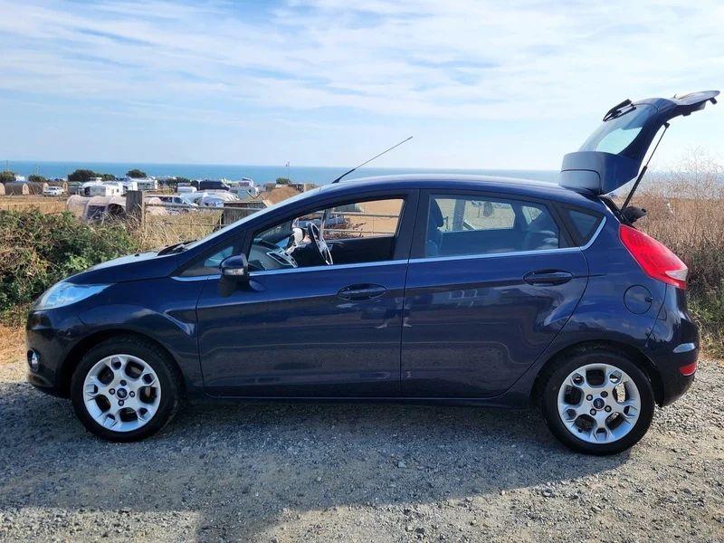 A Deep Midnight Blue Ford Fiesta viewed from the passenger side