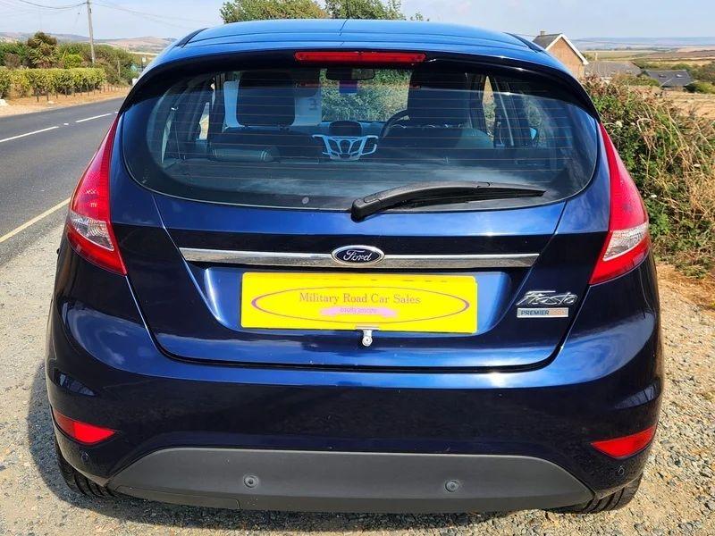 A Deep Midnight Blue Ford Fiesta viewed from the back