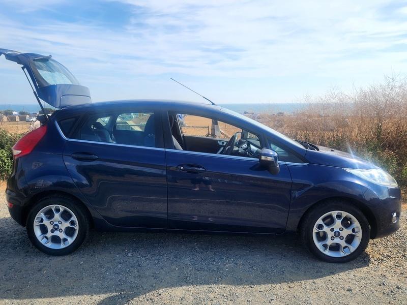 A Deep Midnight Blue Ford Fiesta viewed from the driver side