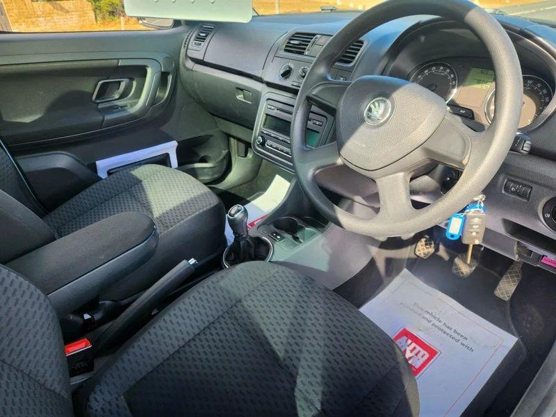 The steering controls of a silver-blue Skoda Roomster viewed from above the driver seat