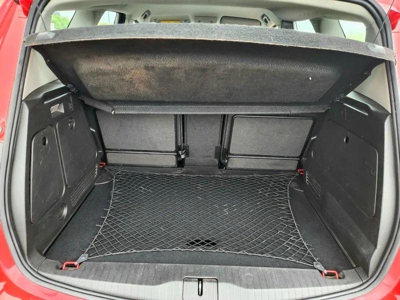 The open boot of a Magma Red Solid Vauxhall Meriva viewed from the back
