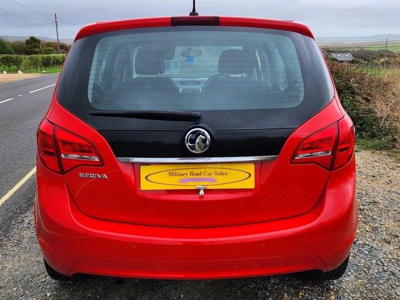 A Magma Red Solid Vauxhall Meriva viewed from the back