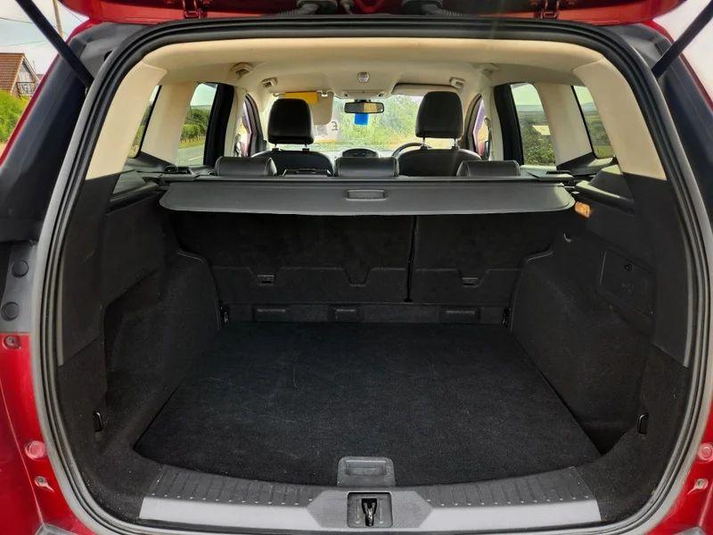 The open boot of a red Ford Kuga viewed from the back