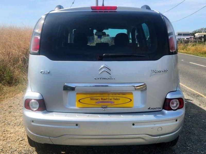 A silver Citroen Picasso viewed from the back