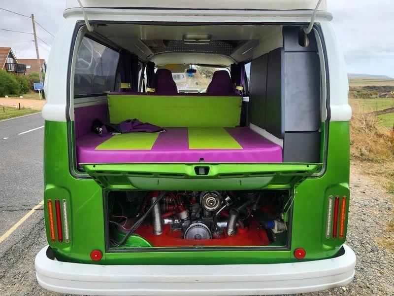 The open boot and engine of a Volkswagen Camper Van viewed from the back