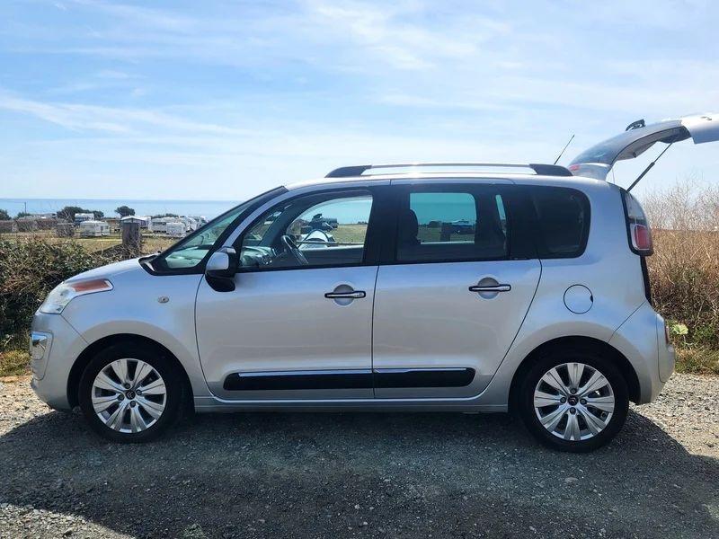 A silver Citroen Picasso viewed from the passenger side