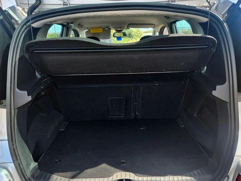 The open boot of a silver Citroen Picasso viewed from the back