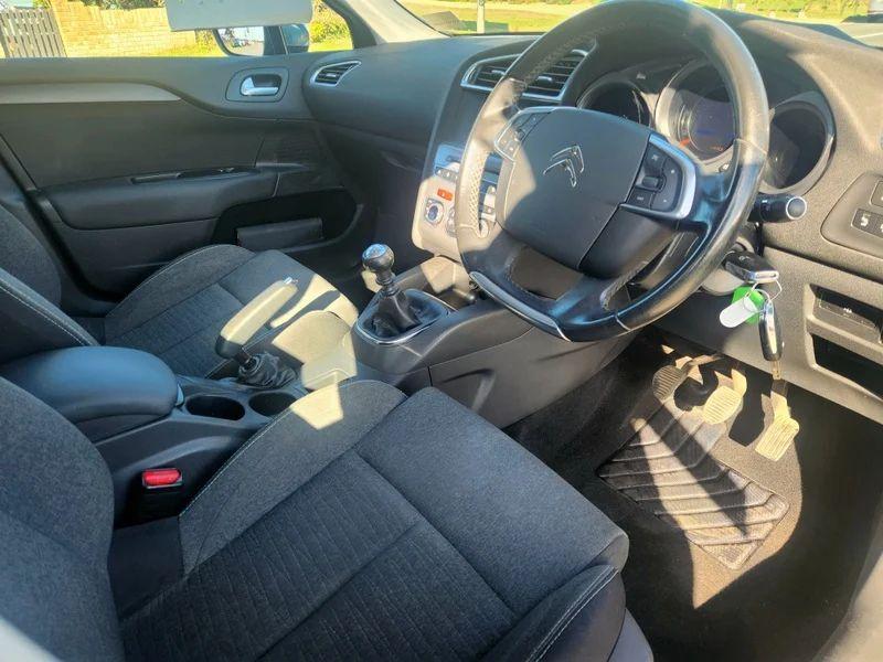The steering controls of a Shark Grey Metallic Citroen C4 viewed from above the driver seat