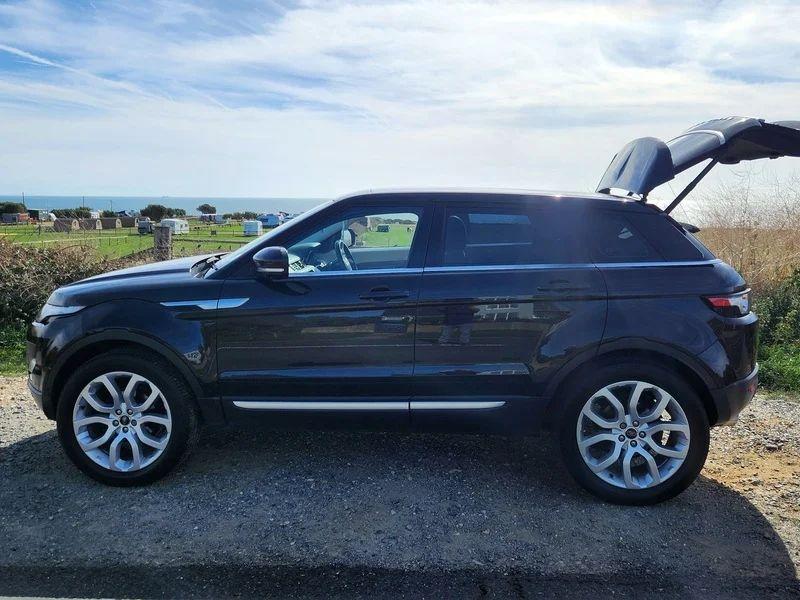 A Santorini Black Range Rover with an open boot viewed from the passenger side