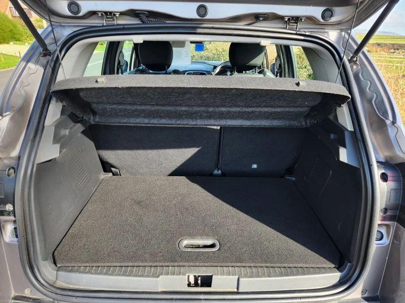 The open boot of a grey Renault Captur viewed from the back