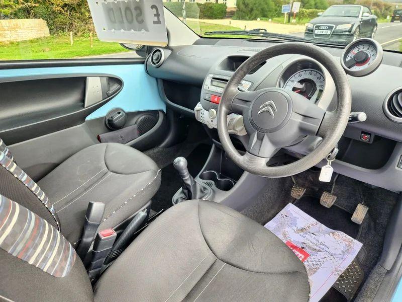 The steering controls of a Botticelli Blue Citroen C1 viewed from above the driver seat