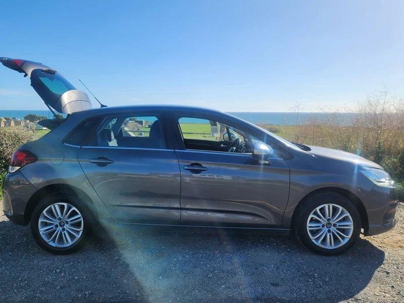 A Shark Grey Metallic Citroen C4 with an open boot viewed from the driver side