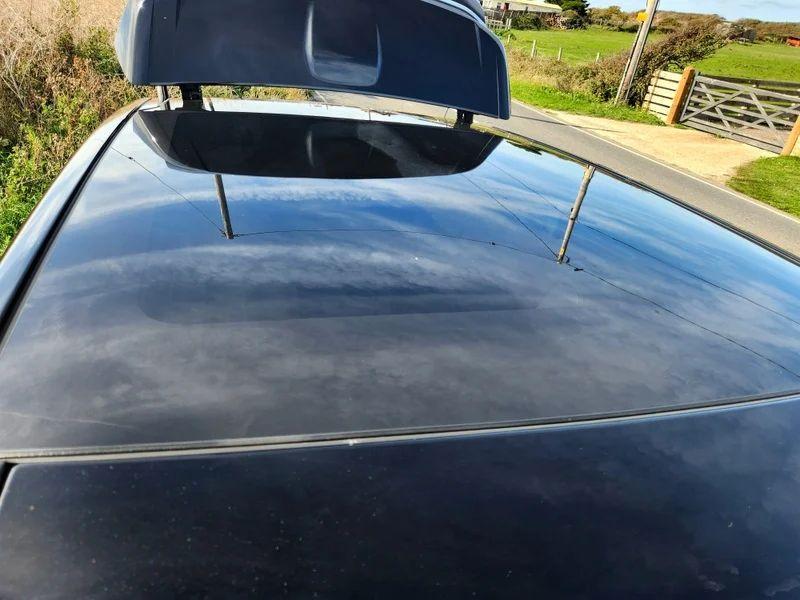 The sunroof of a Santorini Black Range Rover viewed from above