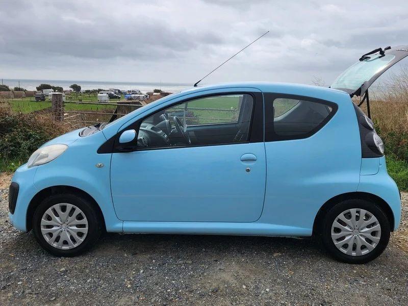A Botticelli Blue Citroen C1 with an open boot viewed from the passenger side