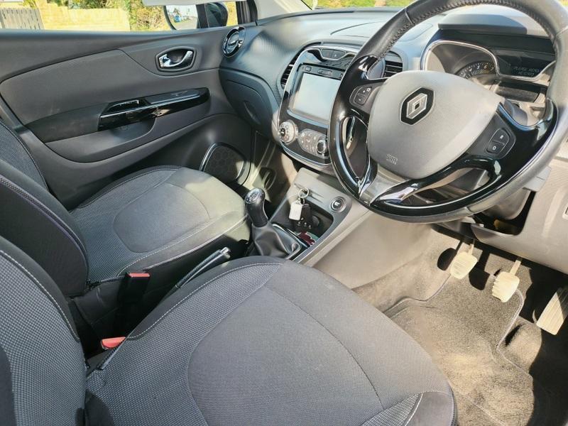 The steering controls of a grey Renault Captur viewed from above the driver seat