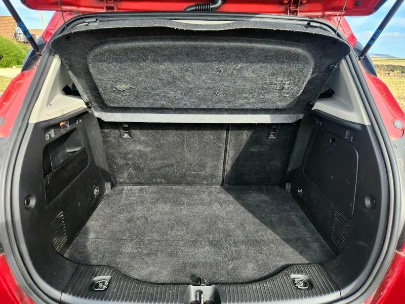 The open boot of a Velvet Red Metallic Vauxhall Mokka viewed from the back