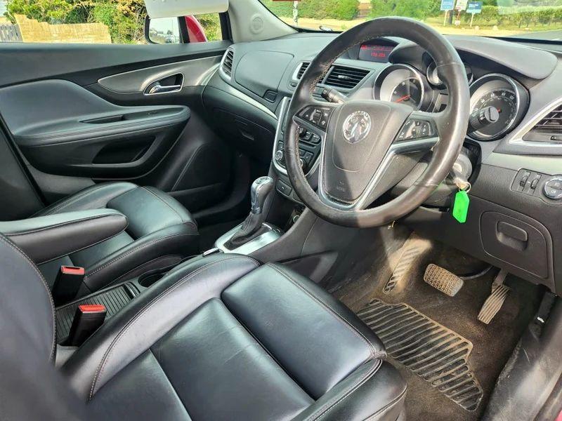 The steering controls of a Velvet Red Metallic Vauxhall Mokka viewed from above the driver seat
