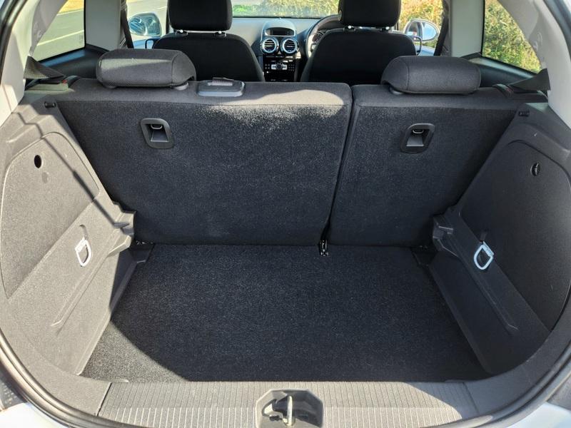 The open boot of a Snow White Vauxhall Corsa viewed from the back