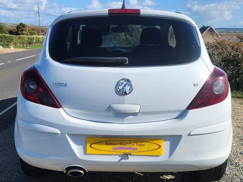 A Snow White Vauxhall Corsa viewed from the back