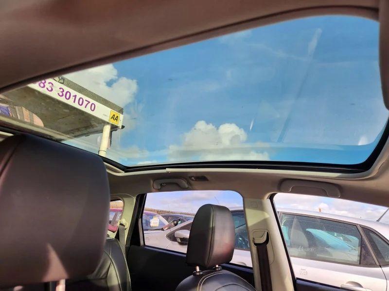 The sunroof of a Nightshade Black Metallic Nissan Qashqai viewed up from the driver seat