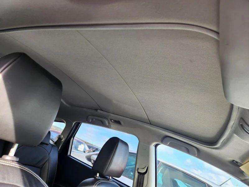 The covered sunroof of a Nightshade Black Metallic Nissan Qashqai viewed up from the driver seat