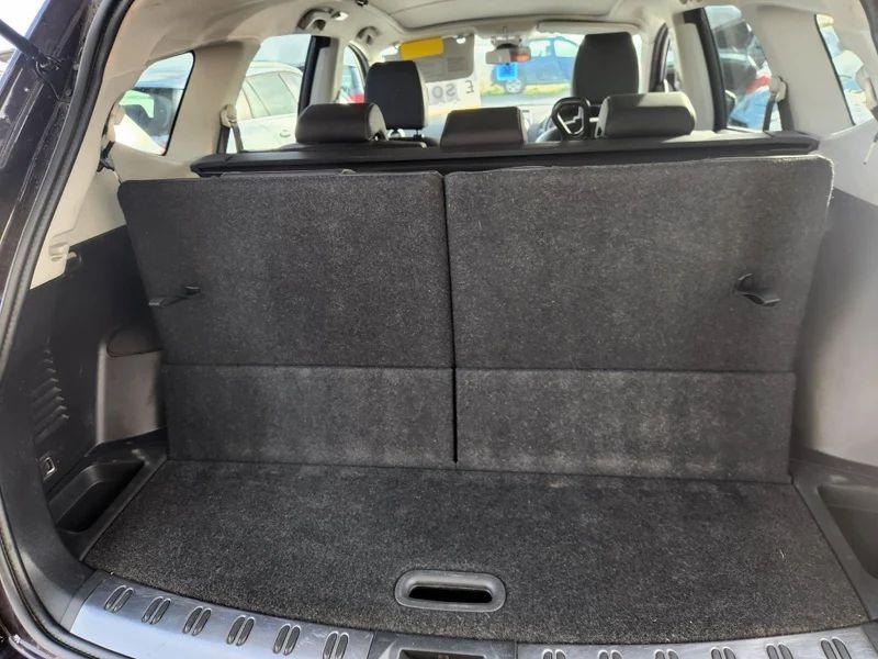 The open boot of a Nightshade Black Metallic Nissan Qashqai viewed from the back