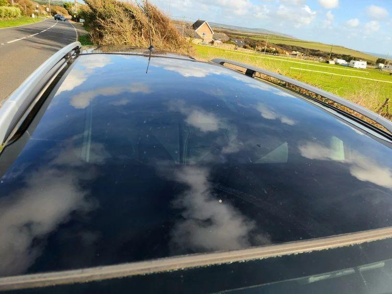 The sunroof of a Nightshade Black Metallic Nissan Qashqai viewed from above
