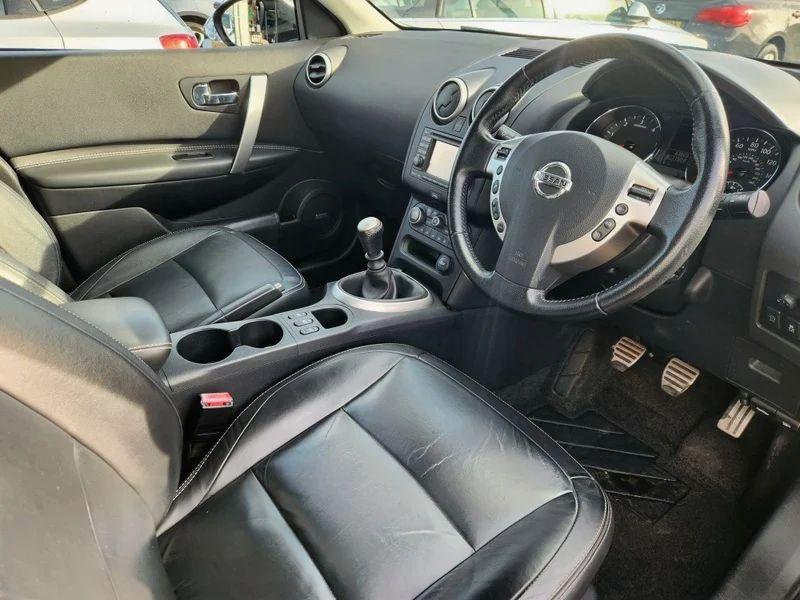 The steering controls of a Nightshade Black Metallic Nissan Qashqai viewed from above the driver seat